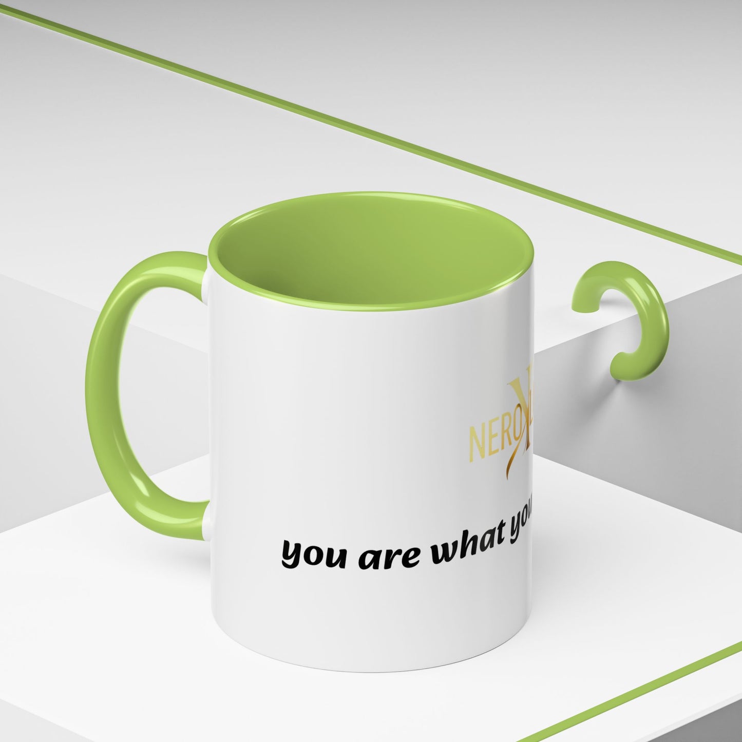 White mug with green interior and handle, featuring text on a white background